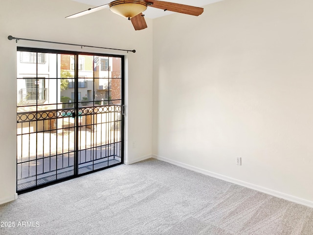 spare room featuring a ceiling fan, baseboards, and carpet floors