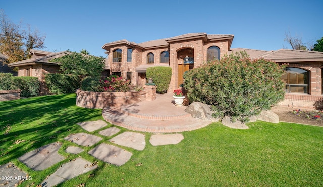 mediterranean / spanish-style house featuring a front lawn