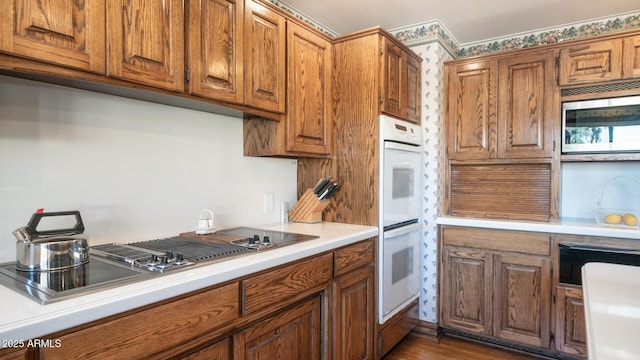 kitchen featuring appliances with stainless steel finishes and dark hardwood / wood-style flooring