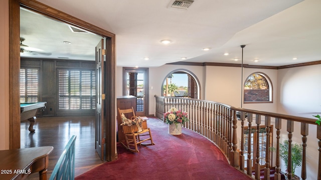 hall with ornamental molding and dark hardwood / wood-style flooring