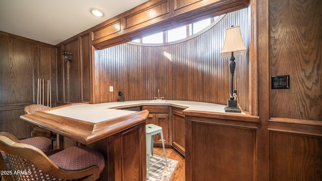 bar with light hardwood / wood-style floors