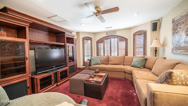 carpeted living room featuring ceiling fan