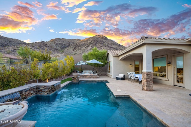 view of swimming pool with a mountain view, a patio, a fenced in pool, and a fenced backyard