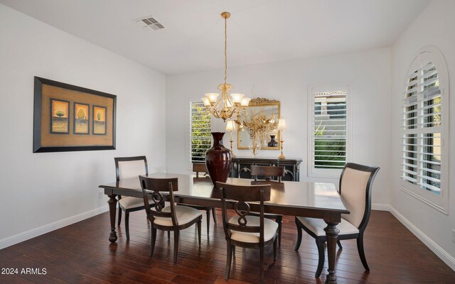 dining room with visible vents, baseboards, and hardwood / wood-style flooring