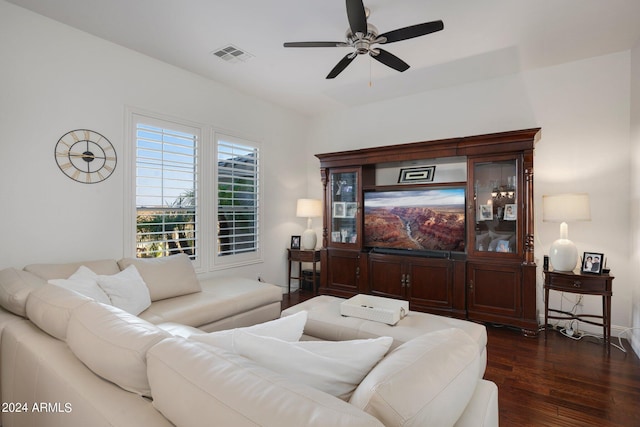 living area featuring dark wood finished floors, a ceiling fan, and visible vents