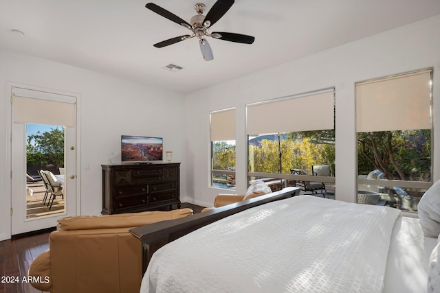 bedroom featuring dark wood-style floors, baseboards, visible vents, ceiling fan, and access to outside