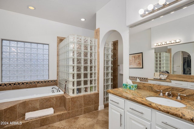 full bath with a bath, recessed lighting, vanity, and walk in shower