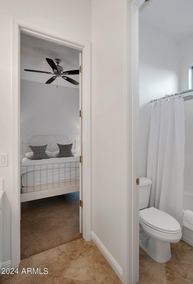 bathroom featuring curtained shower, toilet, and a ceiling fan