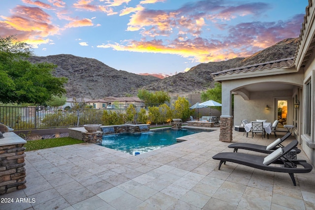 view of swimming pool with a fenced in pool, a patio area, a mountain view, and a fenced backyard