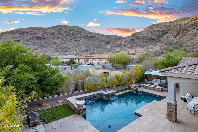 view of swimming pool featuring a mountain view, a patio, and a fenced backyard
