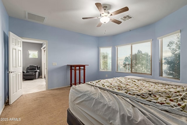 19667 N 260th Ln N, Buckeye, AZ 85396 - bedroom with light carpet, light tile patterned floors, and a ceiling fan