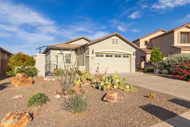 19667 N 260th Ln N, Buckeye, AZ 85396 - view of front facade featuring driveway, stucco siding, a garage, a gate, and a tiled roof
