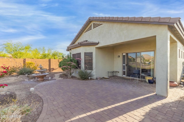 19667 N 260th Ln N, Buckeye, AZ 85396 - rear view of house with a patio area, stucco siding, and a fenced backyard