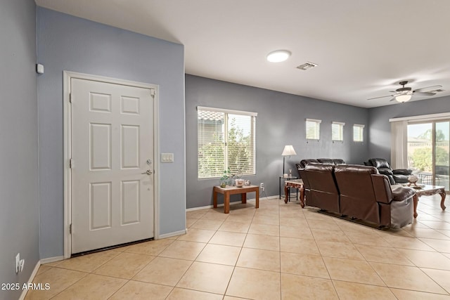 19667 N 260th Ln N, Buckeye, AZ 85396 - living room featuring a ceiling fan, light tile patterned floors, and baseboards