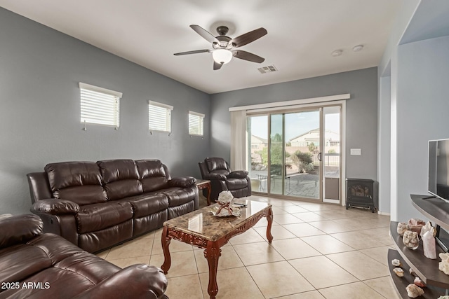 19667 N 260th Ln N, Buckeye, AZ 85396 - living area featuring a wood stove, ceiling fan, and light tile patterned floors