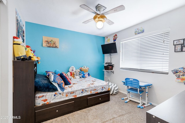carpeted bedroom with baseboards and a ceiling fan
