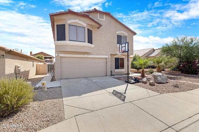 mediterranean / spanish home with a tile roof, driveway, a garage, and stucco siding