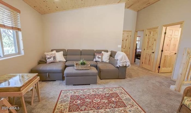 carpeted living room featuring vaulted ceiling and wood ceiling