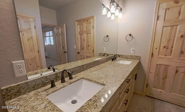 bathroom with double vanity, a sink, and tile patterned flooring