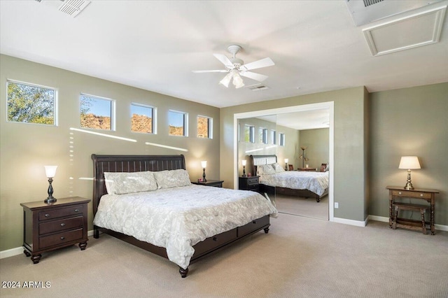 bedroom featuring ceiling fan, a closet, and light colored carpet