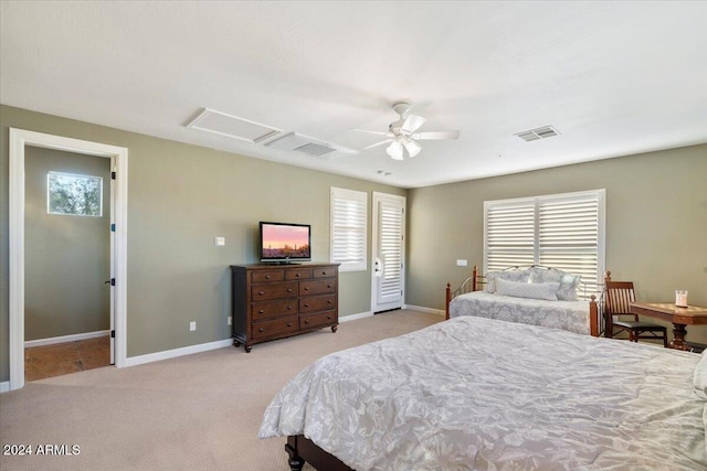 bedroom with ceiling fan, light carpet, and multiple windows