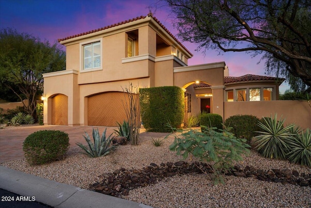 mediterranean / spanish-style house featuring a garage