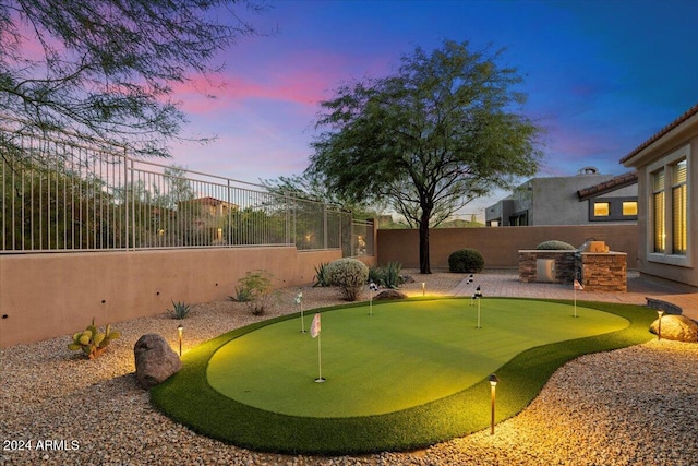 yard at dusk with an outdoor kitchen