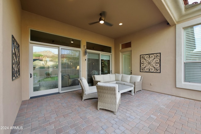 view of patio with an outdoor living space and ceiling fan