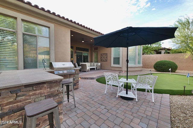 view of patio / terrace with an outdoor living space, an outdoor kitchen, and a bar