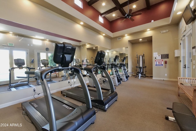 gym featuring ceiling fan, french doors, a towering ceiling, and light carpet