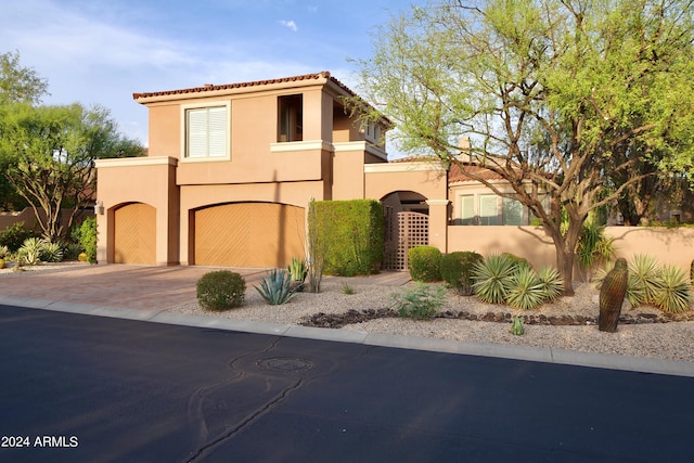 mediterranean / spanish house featuring a garage