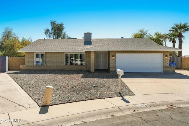 3223 W Purdue Ave, Phoenix, AZ 85051 - single story home featuring brick siding, roof with shingles, a chimney, an attached garage, and driveway