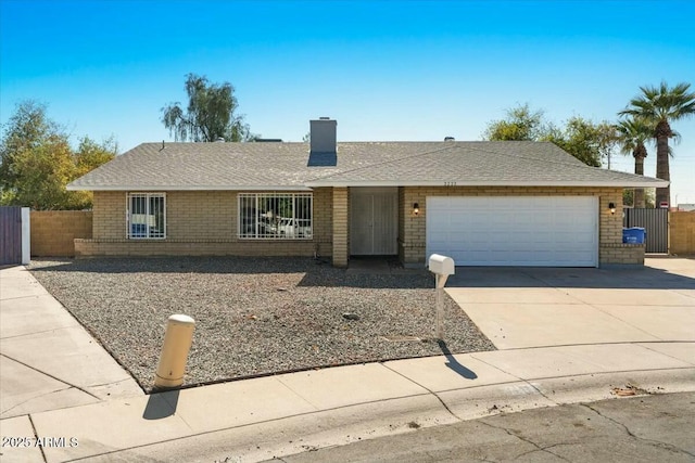 single story home featuring brick siding, roof with shingles, a chimney, an attached garage, and driveway