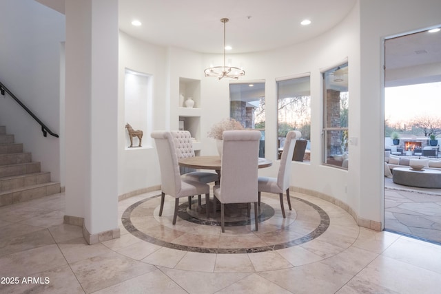 dining area featuring built in shelves and an inviting chandelier