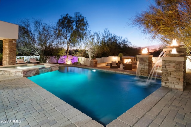 pool at dusk featuring an outdoor living space with a fire pit, a patio, and an in ground hot tub