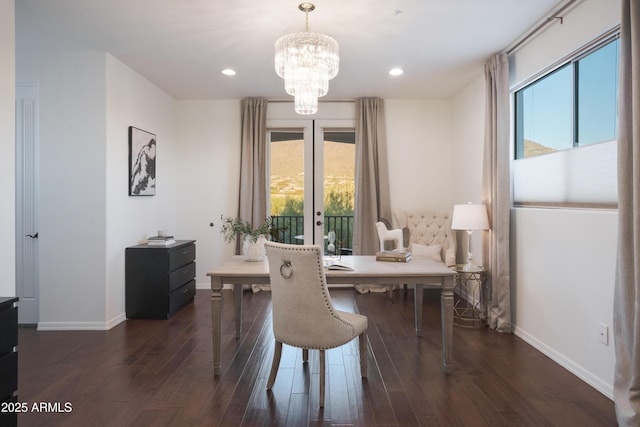 dining space with french doors, dark hardwood / wood-style floors, and a chandelier