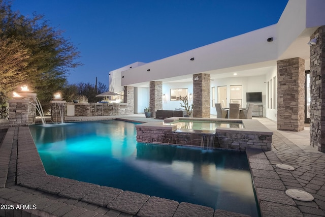 view of pool featuring an in ground hot tub, pool water feature, and a patio area