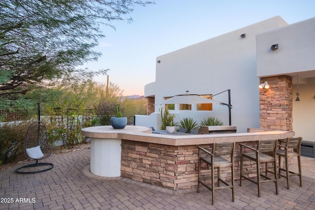 patio terrace at dusk with a bar