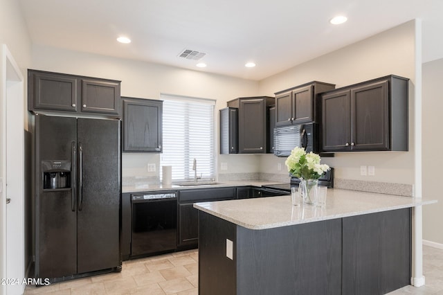 kitchen featuring dark brown cabinets, light stone counters, sink, kitchen peninsula, and black appliances