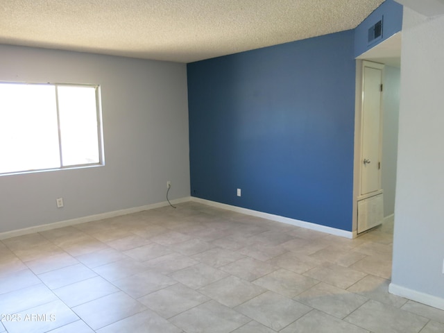 1130 E Butler Dr Unit B4, Phoenix, AZ 85020 - unfurnished room with baseboards, a textured ceiling, and visible vents