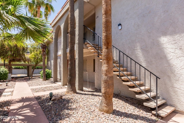 view of property exterior featuring stairs and stucco siding