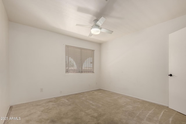 unfurnished room with baseboards, ceiling fan, and carpet
