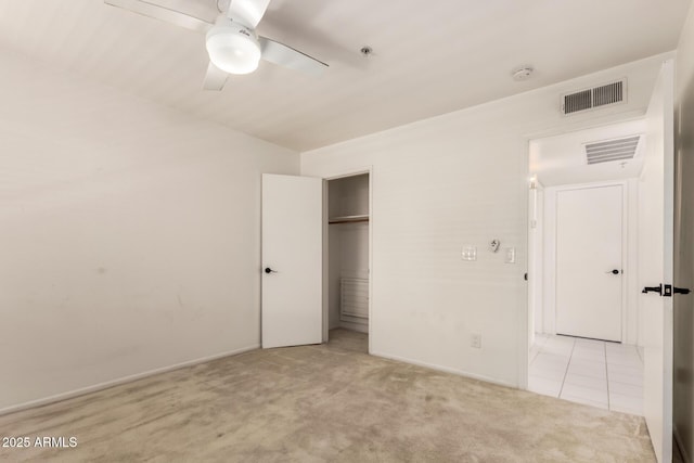 unfurnished bedroom featuring visible vents, a ceiling fan, carpet floors, and a closet