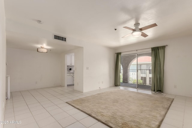 unfurnished room with a ceiling fan, visible vents, and light tile patterned flooring