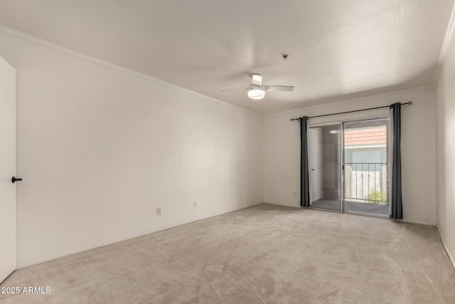 unfurnished room featuring ornamental molding, a ceiling fan, and light colored carpet