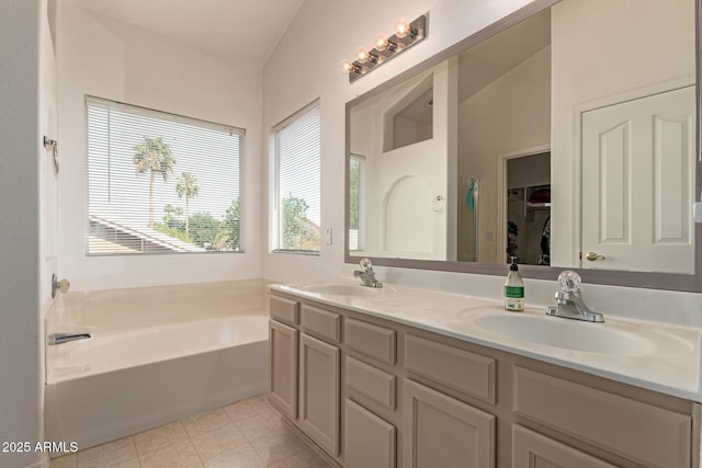 full bathroom with a bath, tile patterned flooring, double vanity, and a spacious closet