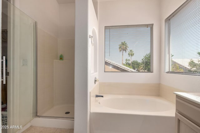 bathroom featuring a shower stall, vanity, a garden tub, and tile patterned floors