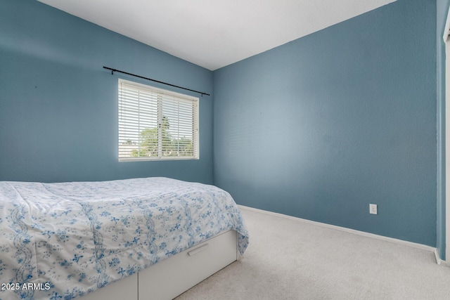 bedroom featuring baseboards and carpet floors