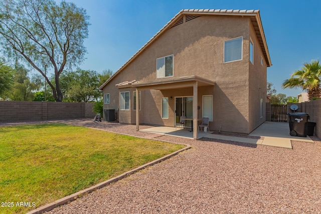 rear view of house with stucco siding, a patio area, a gate, and cooling unit