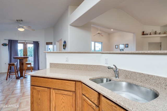 kitchen with french doors, sink, vaulted ceiling, ceiling fan, and light tile patterned floors